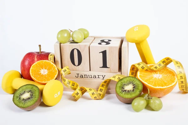 Calendrier cube, fruits, haltères et ruban à mesurer, résolutions du Nouvel An — Photo