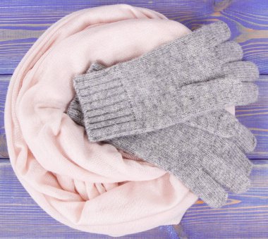 Woolen gloves and shawl for woman on old boards