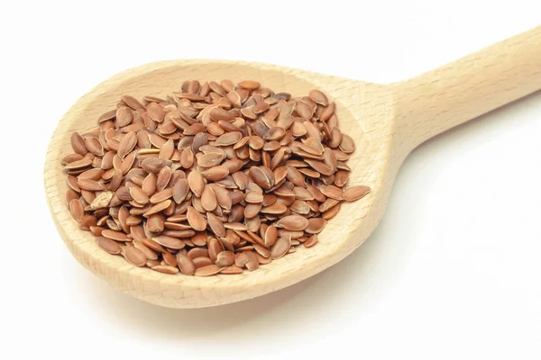 Linseed with wooden spoon. White background. Healthy food containing dietary fiber — Stock Photo, Image