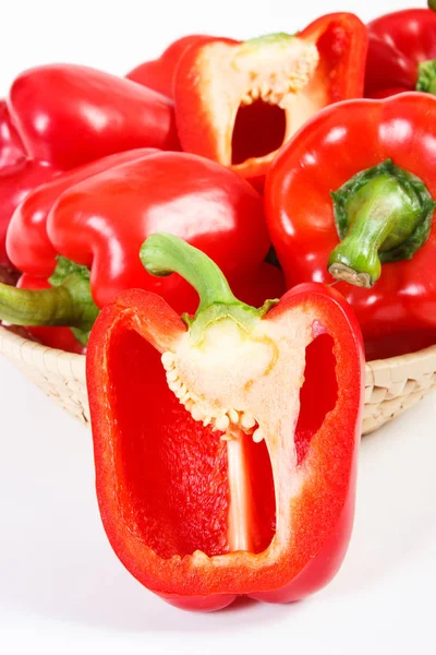 Red peppers with wicker basket on white background, concept of healthy nutrition — Stock Photo, Image