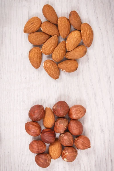 Hazelnuts and almonds as source healthy natural vitamins and minerals, nutritious eating concept