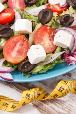 Doğal vitaminler içeren sağlıklı yemek olarak peynirli ve sebzeli meze ve taze Yunan salatası