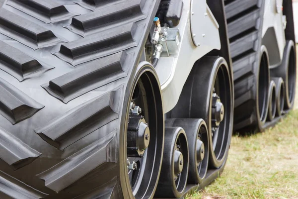 Detail and part of metal wheel with caterpillar. Transportation and technology concept