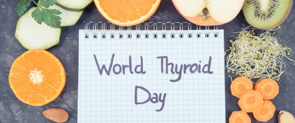 Notepad with inscription World Thyroid Day and best nutritious ingredients for healthy thyroid