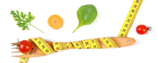 Wooden fork wrapped tape measure and fresh ripe vegetables on white background, concept of lose weight and healthy nutrition