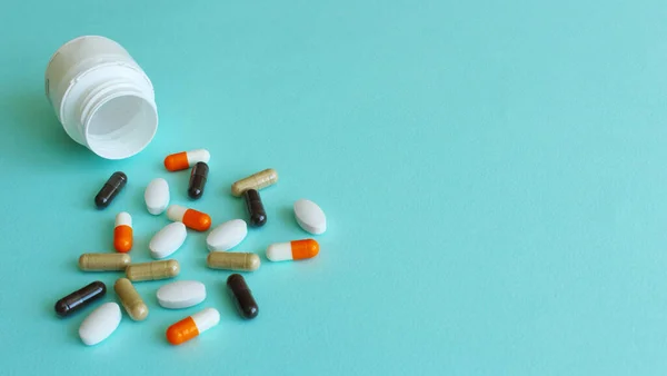 Handful Colored Pills Spilled Out Can Blue Background Medical Concept — Stock Photo, Image