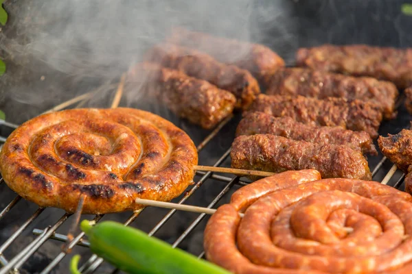 Sosisler ve mici veya mititei adı verilen geleneksel Romen sosisleri (et ve baharat karışımından silindirik şeklinde ızgara et rulolarından oluşan yemek) dumanlı barbekü üzerine