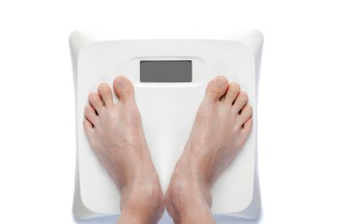 Feet on Bathroom Scale Isolated on White clipart