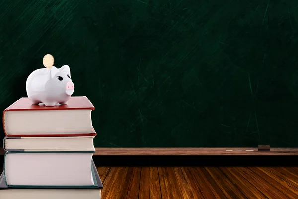 Piggy Bank on Stack of Books and Chalkboard Background — Stock Photo, Image