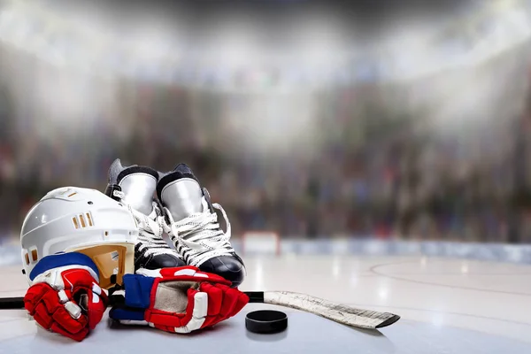 Hokejové helmy, brusle, rukavice, tyč a puk v kluziště — Stock fotografie