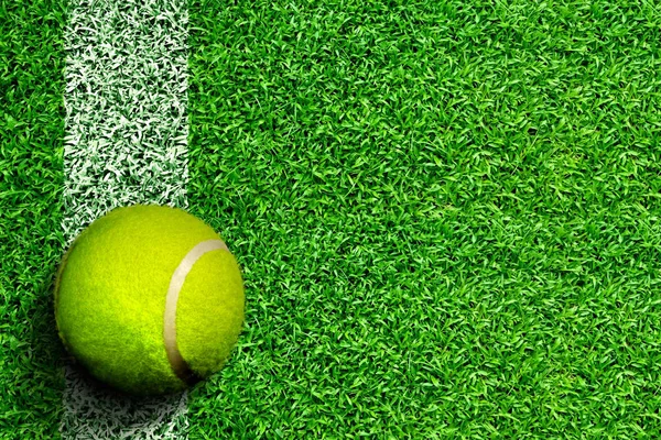 Pelota de tenis en la cancha de hierba con espacio de copia —  Fotos de Stock