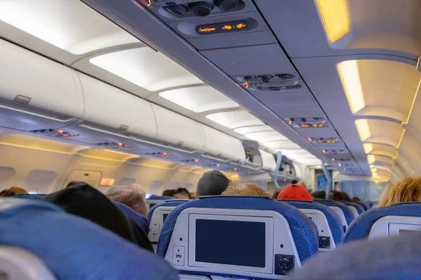 Inside of an airplane cabin with passengers on flight — 스톡 사진