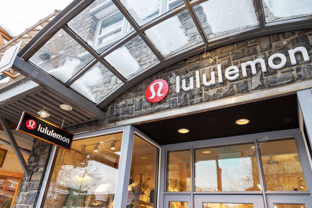 BANFF, CANADA - FEB 15, 2020 : Lululemon store with its sign on busy Banff Avenue in Alberta, Canada. The athletic apparel retailer is made famous for its yoga wear.