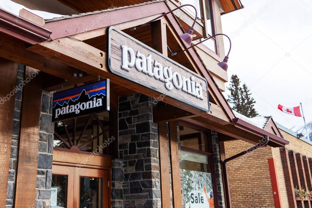 BANFF, CANADA - FEB 15, 2020 : Patagonia store with its sign on busy Banff Avenue in Alberta, Canada. Patagonia is an American clothing company that markets and sells outdoor clothing.