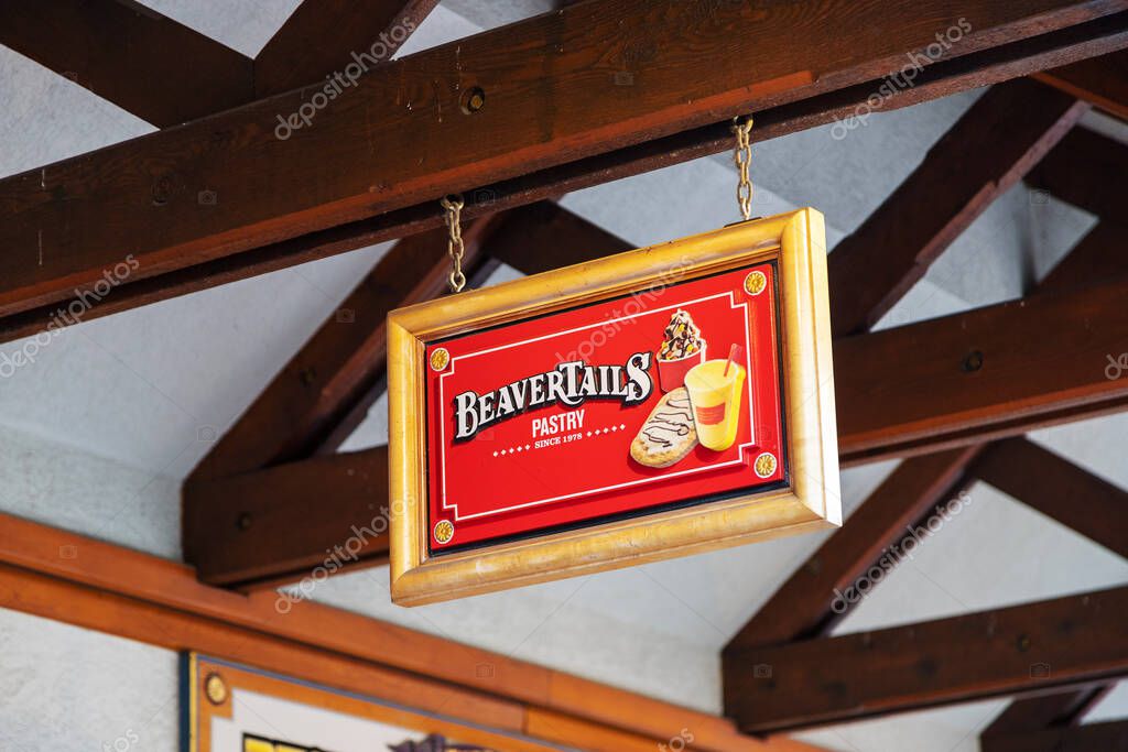 BANFF, CANADA - FEB 15, 2020 : Famous Canadian-based BeaverTails restaurant with its sign on busy Banff Avenue in Alberta, Canada.