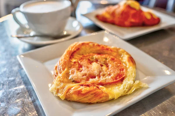 stock image Breakfast tomato tart puff pastry topped with cheese and cup of latte coffee.