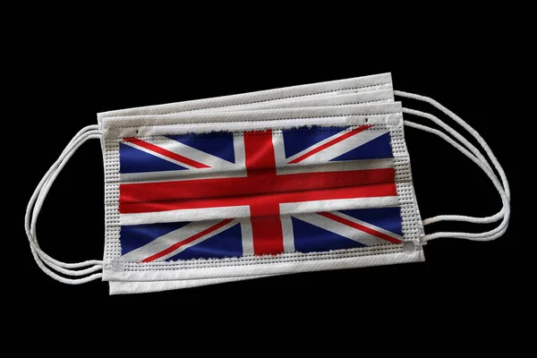 Meerdere Chirurgische Gelaatsmaskers Met Britse Vlag Gedrukt Geïsoleerd Zwarte Achtergrond — Stockfoto