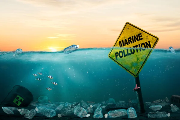 Marine pollution concept showing sunrise over ocean full of plastics, radiation materials and unwanted trash while school of clown fish swim.