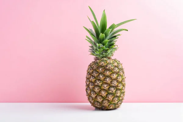 Fresh pineapple over pink background, copy space