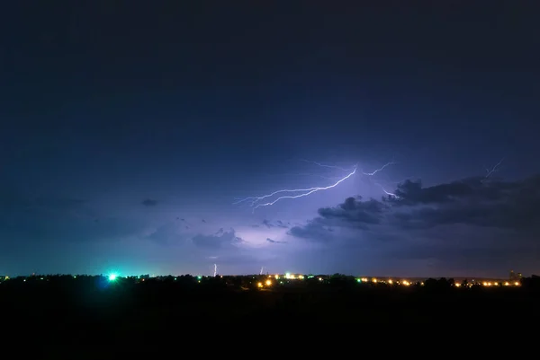 Lightning bolt in the clouds over the countryside