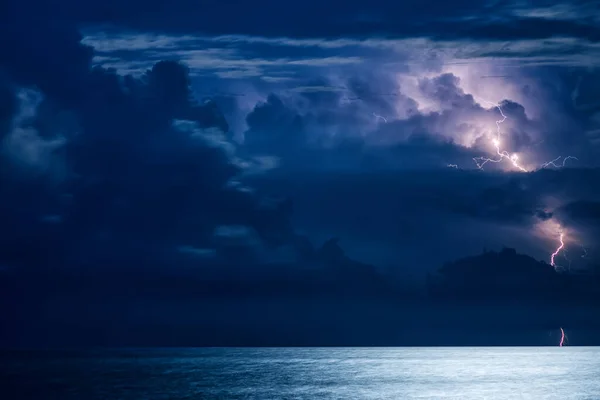 Massive cumulus clouds and lightning at night over the Black sea