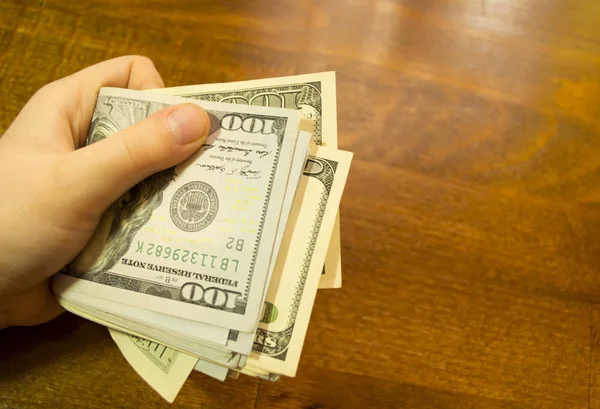 Hands Holding Dollars Wooden Background — Stock Photo, Image