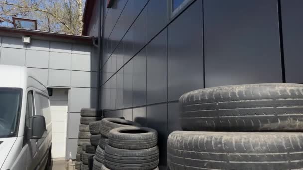 Many Stacked Old Used Tires Stand Gray Wall Next Big — Stock Video