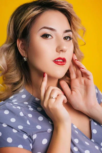 Girl with red lips and a dress in peas on a yellow background. Pin-up Portraits — Stock Photo, Image