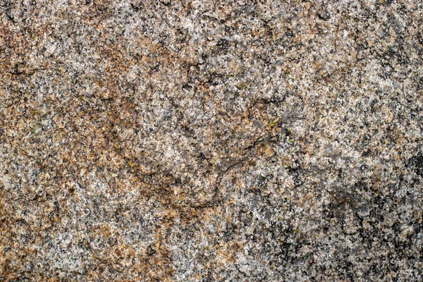 Natural granite texture. Gray granite surface with orange veins. Macro granite texture.
