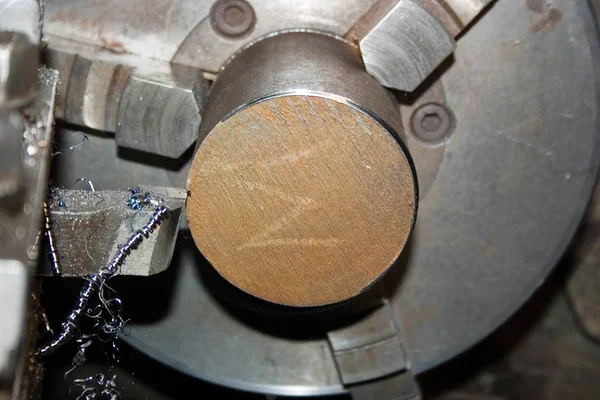 Turning operation. Cutting the end of a metal bar on a lathe. Close-up