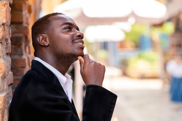 African businessman in suit thinking about business plan