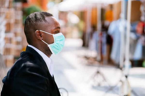 Alone african businessman with medical mask for protect from corona virus or covid-19