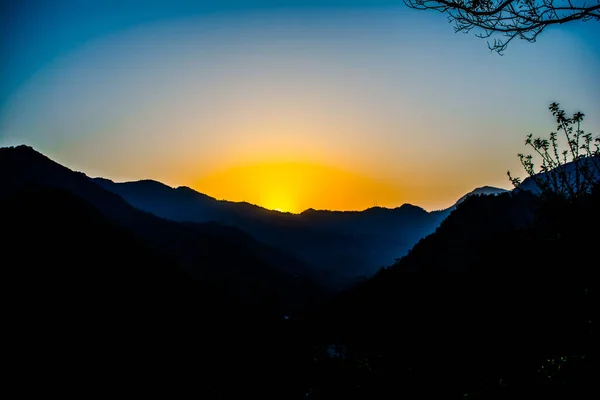 Sunrise behind the mountains of Rishikesh, Located in the foothills of the Himalayas in northern India,