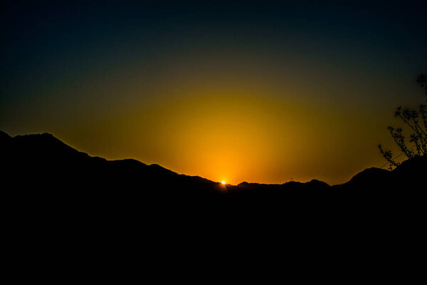 Sunrise behind the mountains of Rishikesh, Located in the foothills of the Himalayas in northern India,