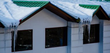 Ice dams with a cold roof at Patnitop Jammu India, Winter landscape clipart