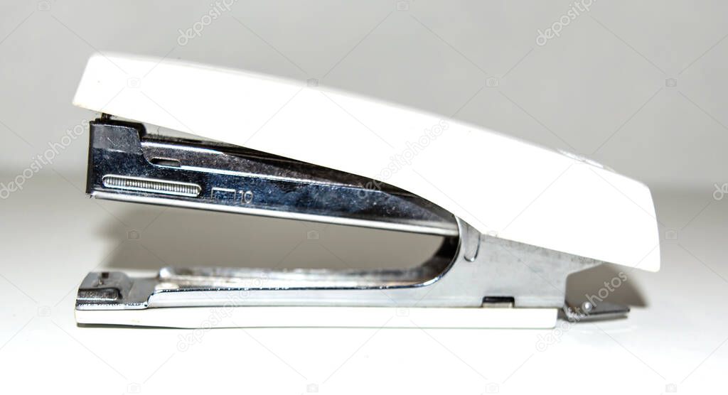 cream color stapler isolated on a white background.