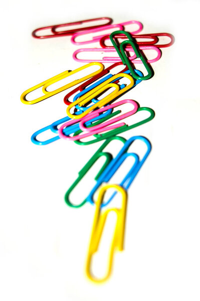 Push pins and paper clips in different colors isolated on white background.