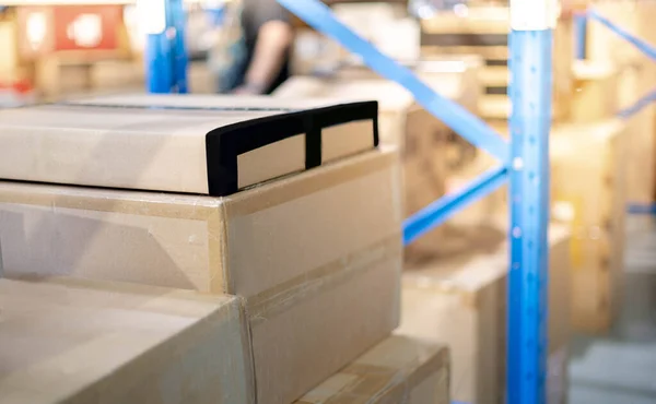 倉庫や倉庫に設置されている棚や青金属ラックに置くための段ボール箱の小包の山 顧客への出荷のための準備小包 — ストック写真