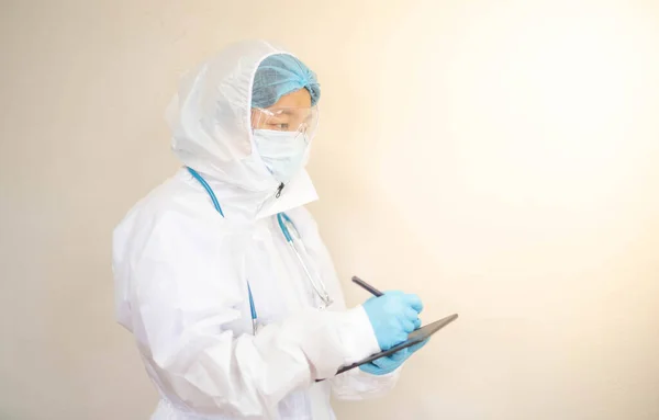 Doctor is wearing PPE suit and looking for corona/covid-19 virus infected patient\'s laboratory report, For protection Coronavirus (COVID19) epidemic. Concept of Covid-19 quarantine for Fighting with Virus.