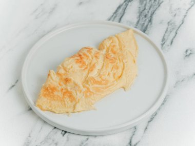 Beyaz mermer arka planda yumurta omleti. Beyaz bir tabakta. Menü için fotoğraf.