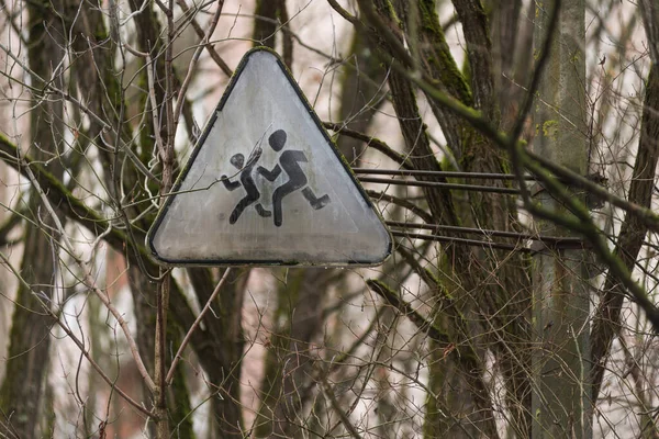 Old road sign in ghost town Pripyat, post apocalyptic city, spring season in Chernobyl exclusion zone, Ukraine