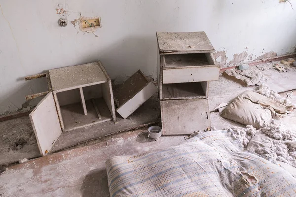 Abandoned hospital room in Pripyat, broken furniture, old dirty bedside table, Chernobyl zone, Ukraine
