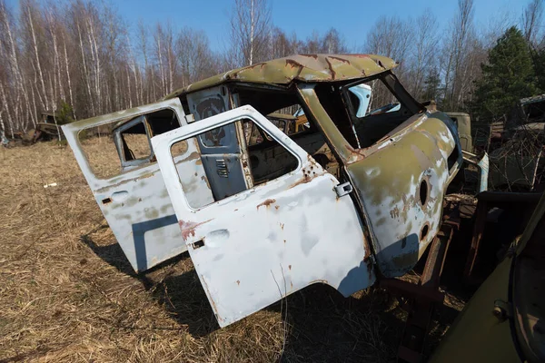 Abandoned radioactive vehicle, old rusty truck, post apocalyptic city, spring season in Chernobyl exclusion zone, Ukraine