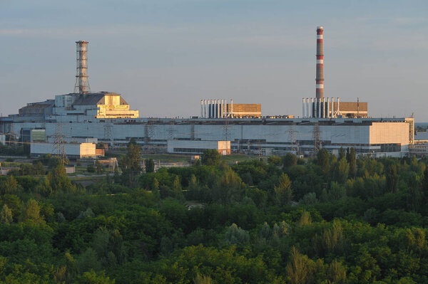 General view of Chernobyl nuclear power plant, view from unfinished unit 5, abandoned Chernobyl station after reactor explosion, object Shelter, old sarcophagus, summer season in exclusion zone, Ukraine
