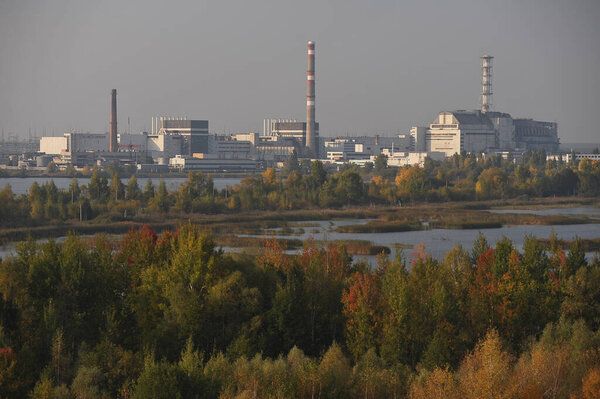General view of Chernobyl nuclear power plant and red forest, abandoned Chernobyl station after reactor explosion, object Shelter, old sarcophagus, autumn season in exclusion zone, Ukraine