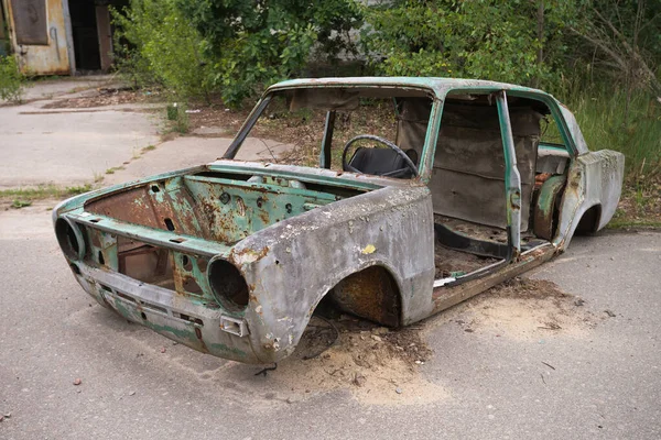 Abandoned radioactive vehicle, old rusty car near ghost town Pripyat, post apocalyptic city, autumn season in Chernobyl exclusion zone, Ukraine