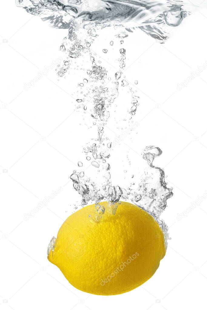 lemon dropped into water isolated on white