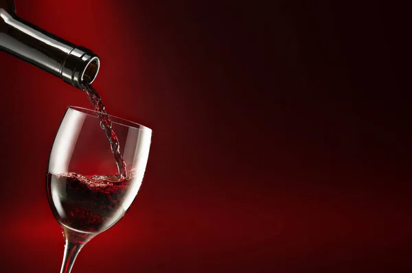 Bottle Pouring Wine Glass Isolated Dark Red Background — Stock Photo, Image