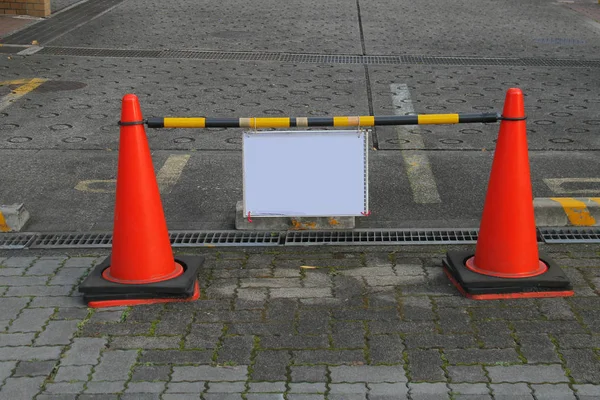 Sign board with red cones on road — Stock Photo, Image