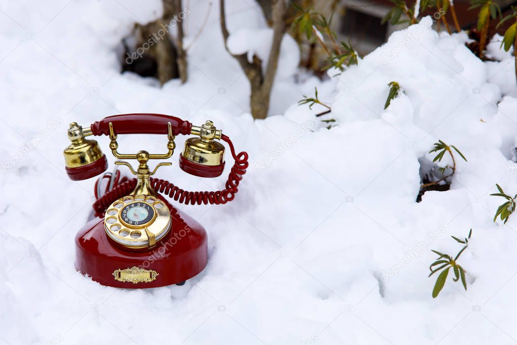 vintage telephone on the snow.